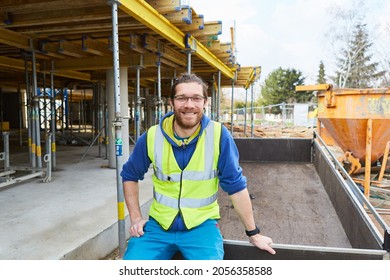 Smiling Construction Worker Or Craftsman Apprentice On The Shell Of A Construction Site For House Building