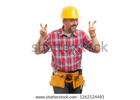 Smiling constructor making quotation marks gesture with fingers in the air as friendly joke concept isolated on white