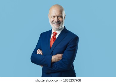 Smiling corporate businessman posing with arms crossed - Shutterstock ID 1883237908