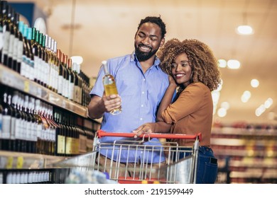 Smiling couple deciding what wine to buy in grocery store - Powered by Shutterstock