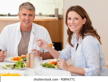 Smiling Couple Eating Dinner Together
