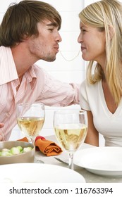 Smiling Couple Eating Spaghetti With The Wife Eating From One End And The Husband The Other End Of The Same Strand