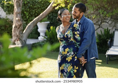 Smiling couple flirting in garden - Powered by Shutterstock