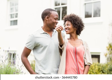 Smiling Couple Holding Keys To Their House