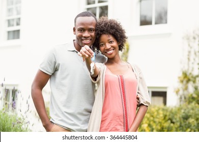 Smiling Couple Holding Keys To Their House