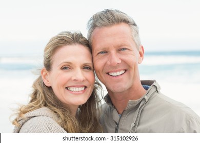 Smiling Couple Holding One Another At The Beach