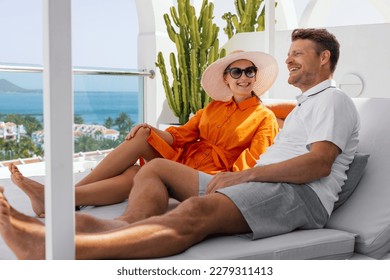 smiling couple relaxing in sunbed and enjoy the summer vacation at luxury villa terrace - Powered by Shutterstock