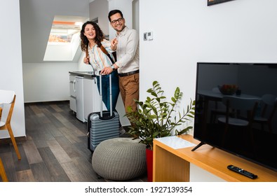 Smiling Couple With Suitcase Arriving In Hotel Room.