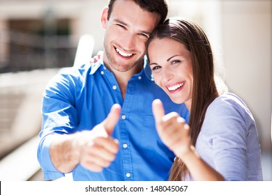 Smiling Couple With Thumbs Up 