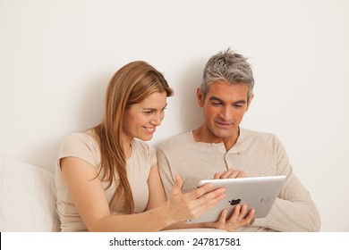 Smiling Couple Using The Ipad
