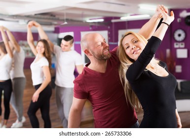 Smiling Couples Enjoying Of Partner Dance Indoor