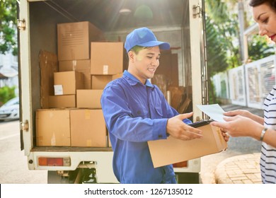 Smiling Courier Giving Document And Parcel To Customer