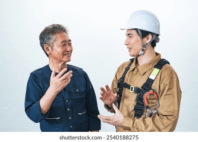 A smiling craftsman and worker having a conversation - Powered by Shutterstock