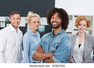 Smiling Creative African American Businessman Standing With Folded Arms In Front Of His Diverse Successful Business Team