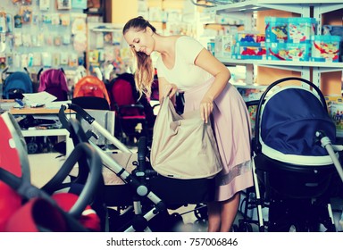 Smiling  Customer Buying Pram For Newborn In Infant Shop