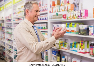 Smiling customer looking at medicine in the pharmacy