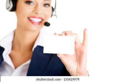 Smiling Customer Service Representative With Headset Holding A Blank Empty Card. Isolated On White Background. 