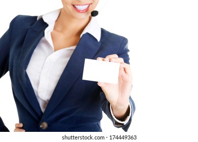 Smiling Customer Service Representative With Headset Holding A Blank Empty Businesscard. Isolated On White Background. 