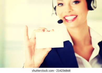 Smiling Customer Service Representative With Headset Holding A Blank Empty Card. Isolated On White Background.