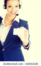 Smiling Customer Service Representative With Headset Holding A Blank Empty Businesscard. Isolated On White Background.