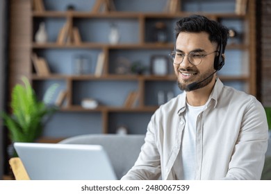 Smiling customer service representative working remotely from home office with headset and laptop. Professional support agent providing customer care while maintaining a positive , friendly attitude - Powered by Shutterstock