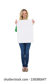 Smiling cute blonde holding white sign on white background
