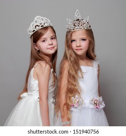 Smiling Cute Little Girls In White Dresses And A Crown For The Beauty Contest