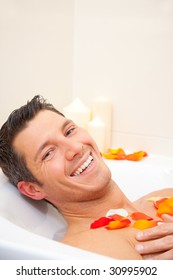 Smiling cute man having a joyful morning in bathtub