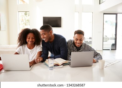 Smiling Dad Helping His Teen Kids With Their Homework, Front View, Close Up