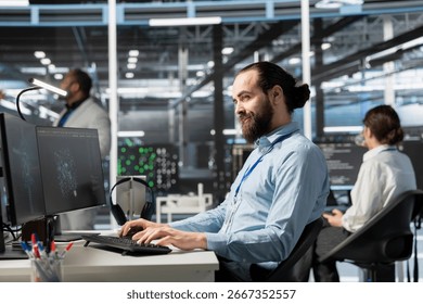 Smiling data center IT professional using artificial intelligence neural networks technology on PC. Happy server farm admin using AI programming language on computer to update hardware