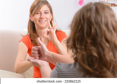 Smiling Deaf Woman Learning Sign Language And Talking With Her Teacher