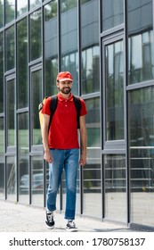 Smiling Delivery Man In Uniform And Thermo Backpack Walking On Urban Street