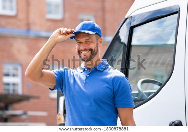 Smiling\
Delivery Men Or Handyman In Uniform Near\
Truck