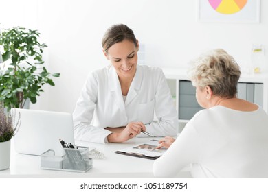 Smiling Dietician And Patient With Nutritional Problems Preparing A Diet Plan During A Meeting