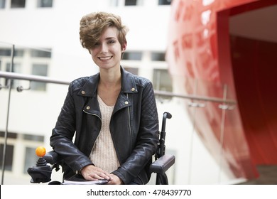 Smiling disabled female university student on mezzanine