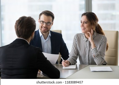 Smiling diverse HR managers satisfied about male job employee, have positive first impression of candidate, happy employers listen to applicant at interview excited of candidature. Recruitment concept - Shutterstock ID 1183089457