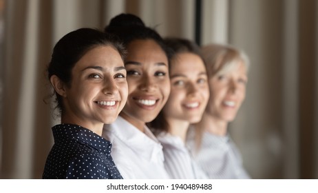 Smiling Diverse Multiracial Female Employees Workers Show Team Unity And Leadership At Workplace. Happy Multiethnic Women Colleagues Coworkers Feel Motivated In Office. Success, Recruitment Concept.