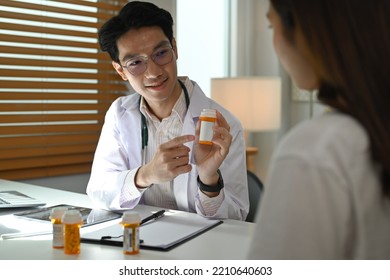 Smiling Doctor Explaining Medicine Dosage To O Patient. Medicine, Healthcare And People Concept 