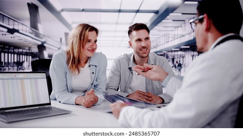 Smiling Doctor Explaining Pregnancy Test Results to Expectant Couple in Clinic - Medical Professional in Consultation with Patients. - Powered by Shutterstock