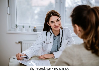 Smiling Doctor Giving Good News. Doctor Reviewing Good Test Results To A Patient.