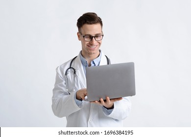 Smiling Doctor In Glasses And Laptop In Hands On White Background