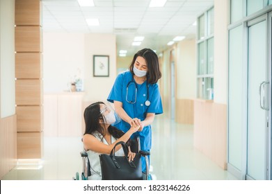 The Smiling Doctor And Medical Nurse Staff Take Care Of Wheel Chair Patient At The Healthcare Hospital By Wearing Face Mask And Stethoscope