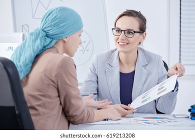 Smiling Doctor Showing A Chart To Her Cancer Patient