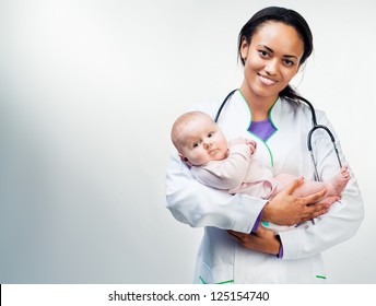 Smiling doctor with small baby isolated on a light background