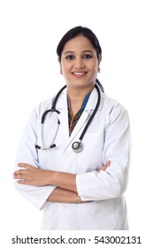 Smiling Doctor Woman With Arms Crossed Against White Background