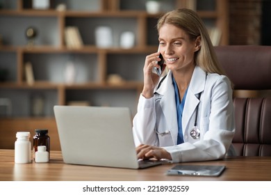 Smiling Doctor Woman Talking On Cellphone And Using Laptop At Workplace, Beautiful Female Therapist Having Mobile Conversation With Sick Patient, Giving Recommendations Online, Copy Space