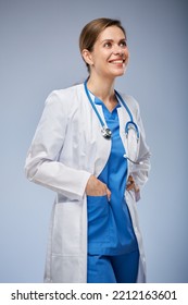 Smiling Doctor Woman In White Coat And Midical Suit Looking Away. Isolated Portrait.