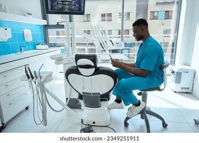 Smiling doctor writing message on smartphone in the hospital - Powered by Shutterstock