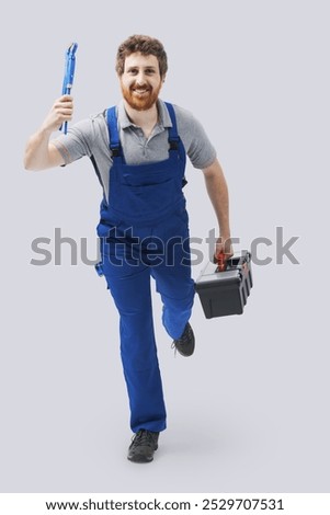 Smiling efficient plumber running fast and holding tools, plumbing service and emergency concept