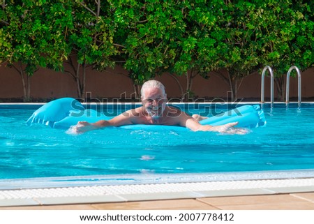 Similar – Ein Mann mit Sonnenhut und einer gelben Gummiente in einem Pool.